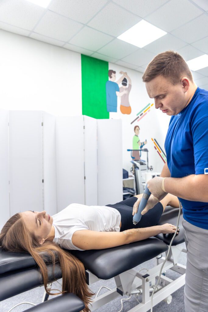 physiotherapist treats female patient arm modern rehab studio wellness recovery session